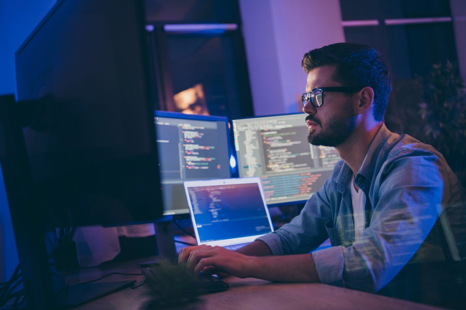A public-private partnerségek szerepe a digitális készségek fejlesztésében Egy ember gépel a számítógép körül más képernyők